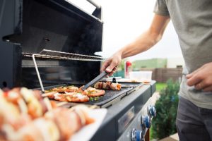 Hand,of,young,man,grilling,some,meat,and,vegetable Meat,skewers