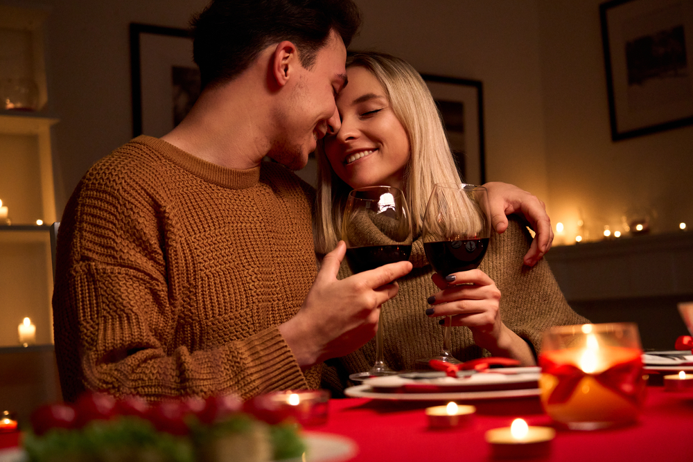 Happy,young,couple,in,love,hugging,holding,glasses,,drinking,wine,